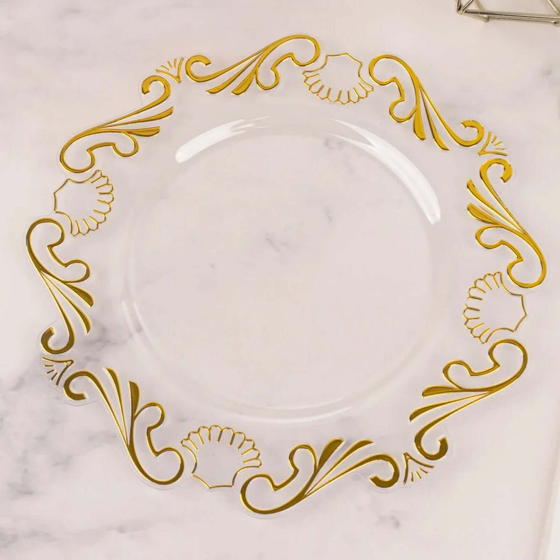 Clear plate with elegant gold scroll design on the rim.