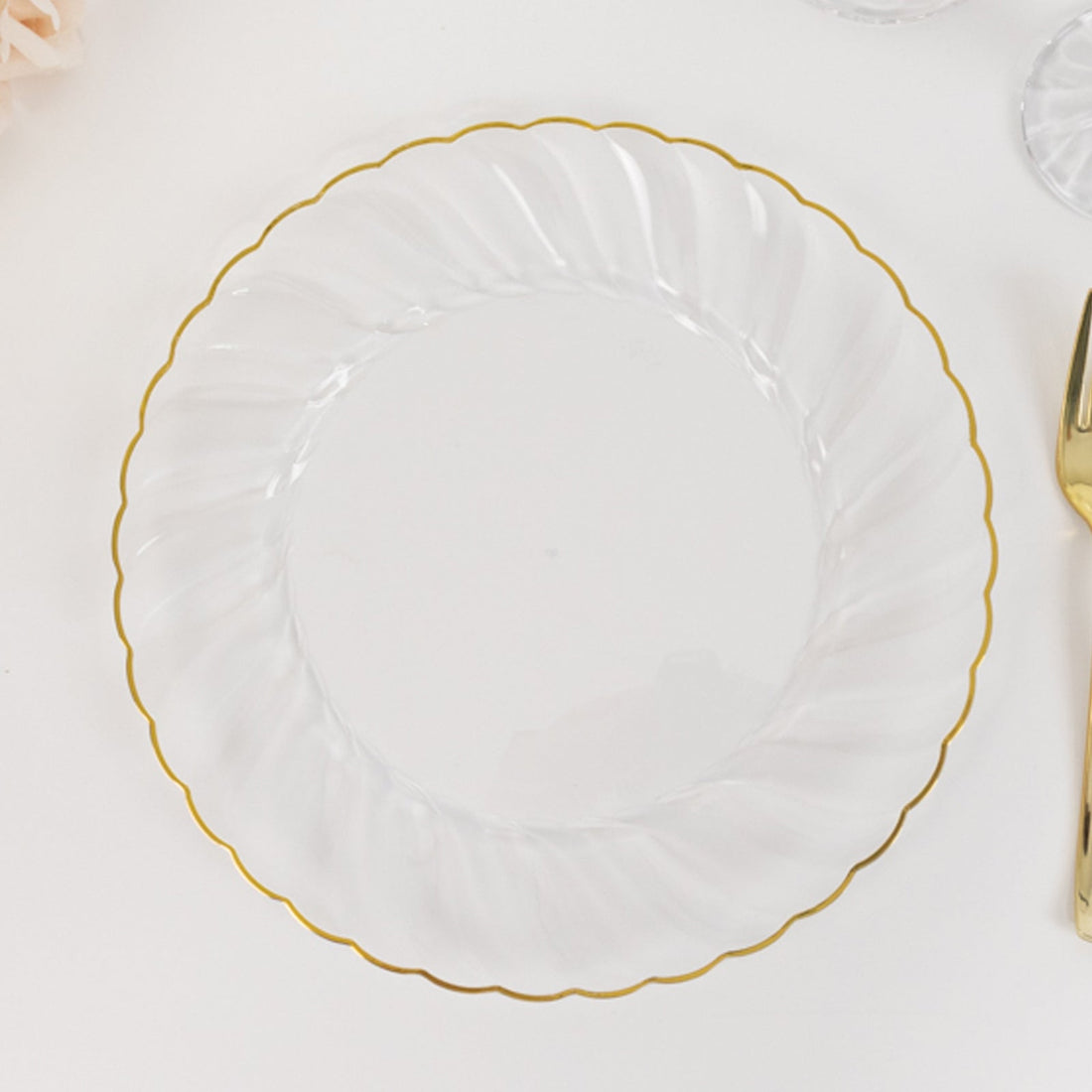 Clear decorative plate with gold scalloped edge.