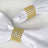 White napkin rings adorned with golden rhinestones.