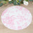 Floral patterned round table mat on a wooden surface.