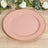 Pink plate with gold beaded edge on a wooden surface.