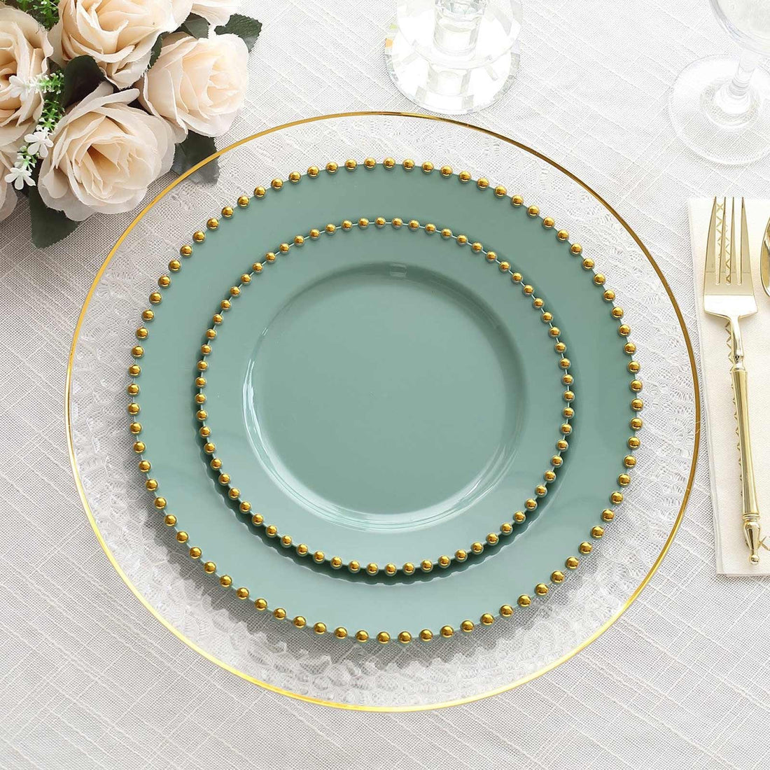 Elegant teal plates with gold beaded accents on a textured table setting.