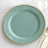 Elegant teal plate with gold beaded rim on a textured tablecloth.