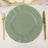 Green decorative plate with gold rim, set on a table with elegant cutlery.
