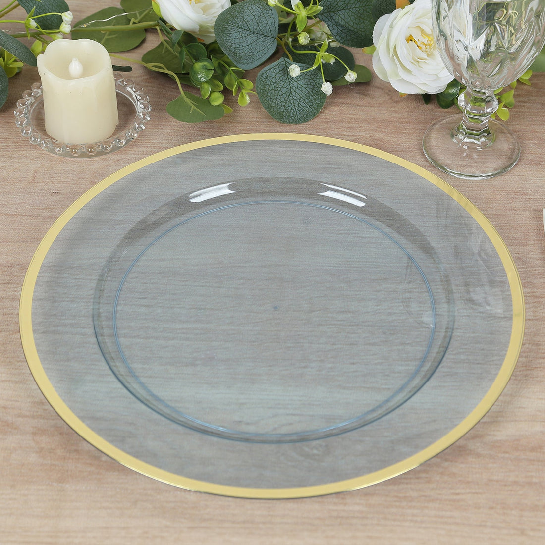 Elegant gray plate with gold rim on wooden table