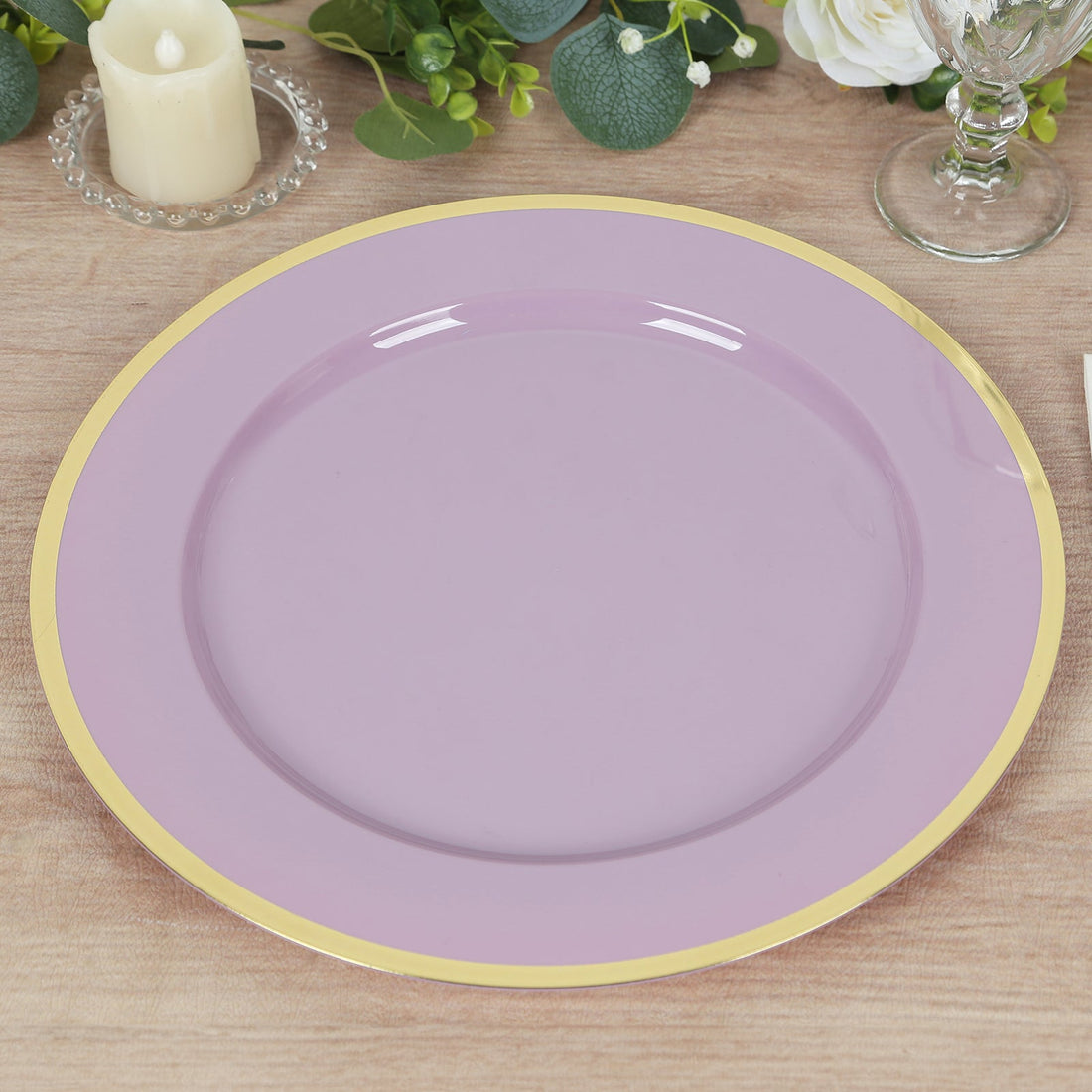 Purple plate with a gold rim on a wooden table.