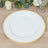 White plate with gold rim on a wooden table setting.