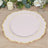 Pink decorative plate with gold trim on a wooden surface.