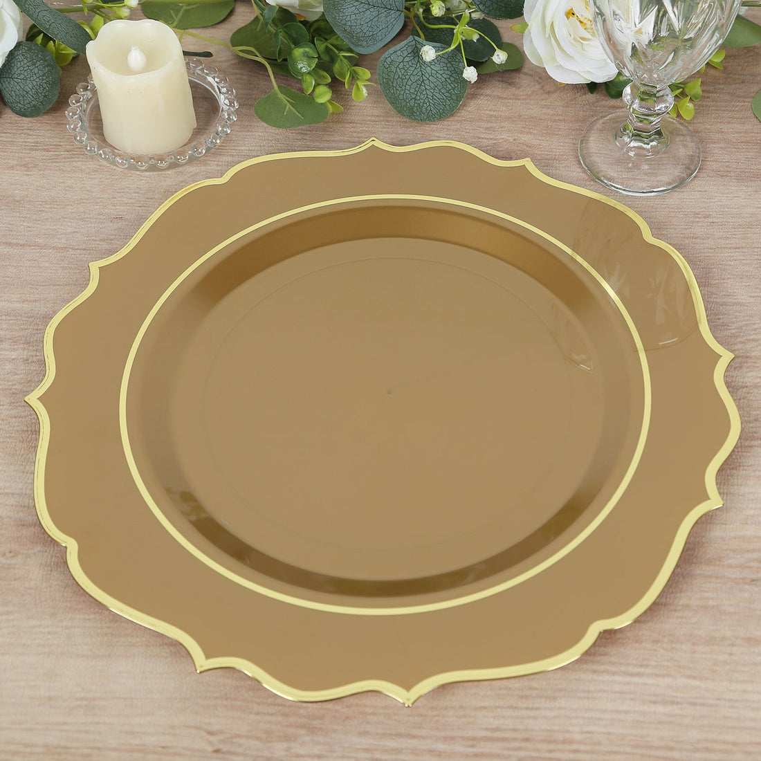 Gold decorative charger plate with scalloped edges on a wooden table.