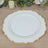 Elegant white plate with gold trim on a wooden table setting.