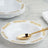 Elegant white bowl with gold ornate design and golden serving spoon.