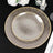 Elegant textured dinner plates with golden rim on a black table setting.