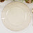 Elegant glass plate with gold rim design on a textured white background.