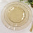 Elegant gold rimmed glass plate set on a textured tablecloth.