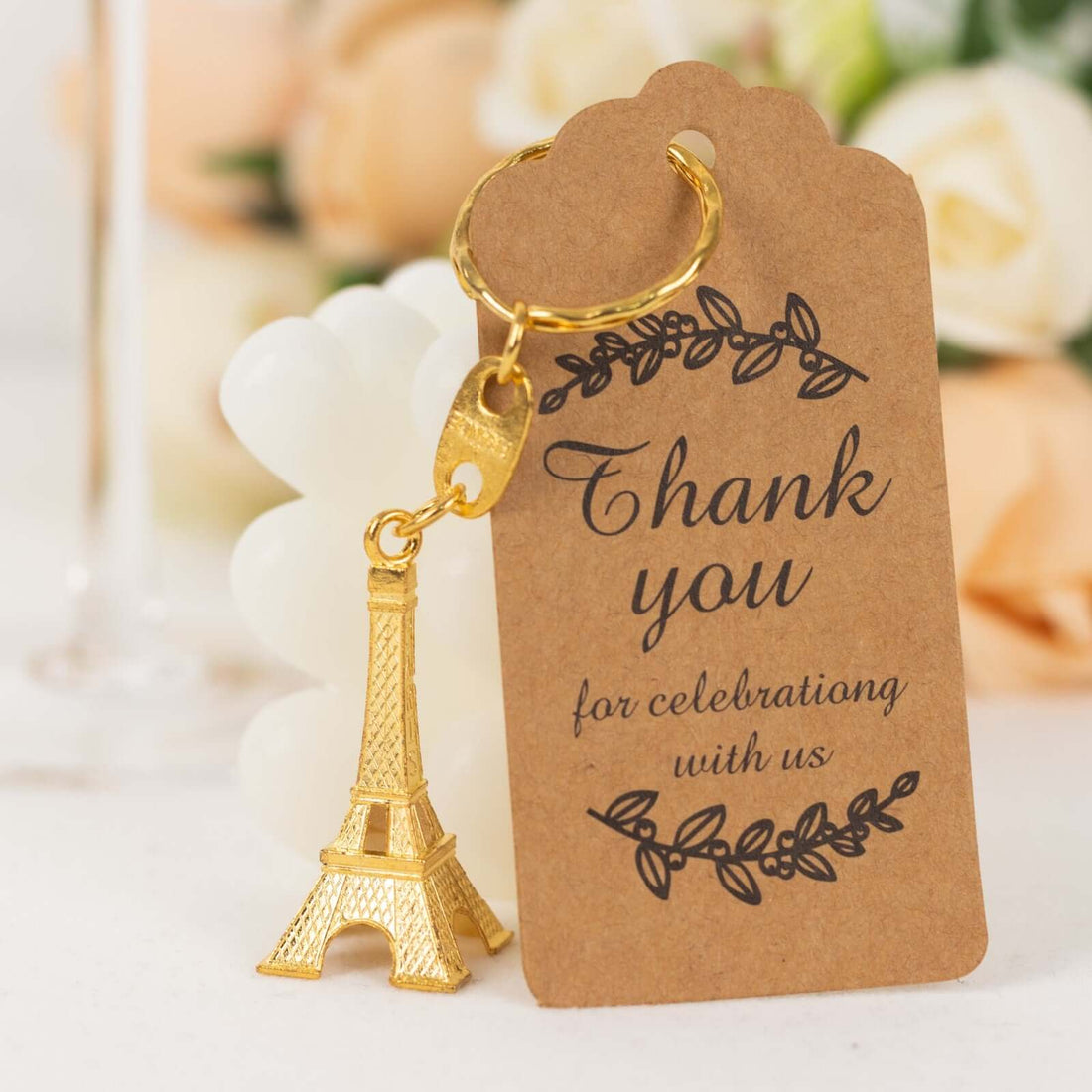 Eiffel Tower keychain with a thank you tag for celebrations.