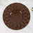 Brown decorative plates stacked on a marble surface.