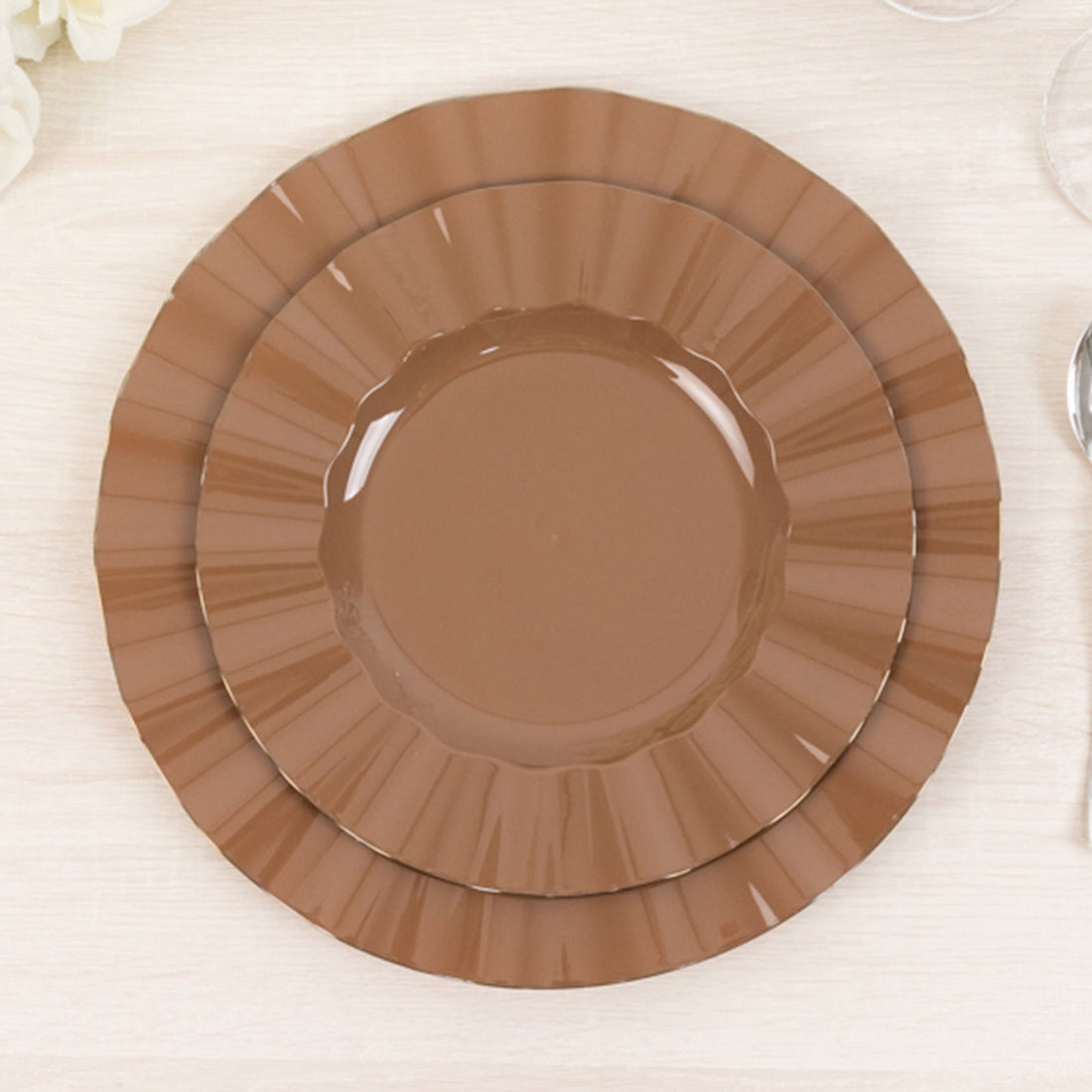Brown decorative plates stacked in a layered design.
