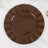 Brown decorative plate with fluted edges on a marble surface.