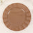 Brown decorative plate with a fluted edge on a plain background.