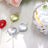 Heart-shaped cake toppers in silver, gold, and red on a soft background.