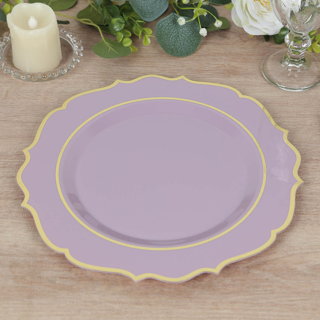Lavender decorative plate with gold trim on a wooden table.