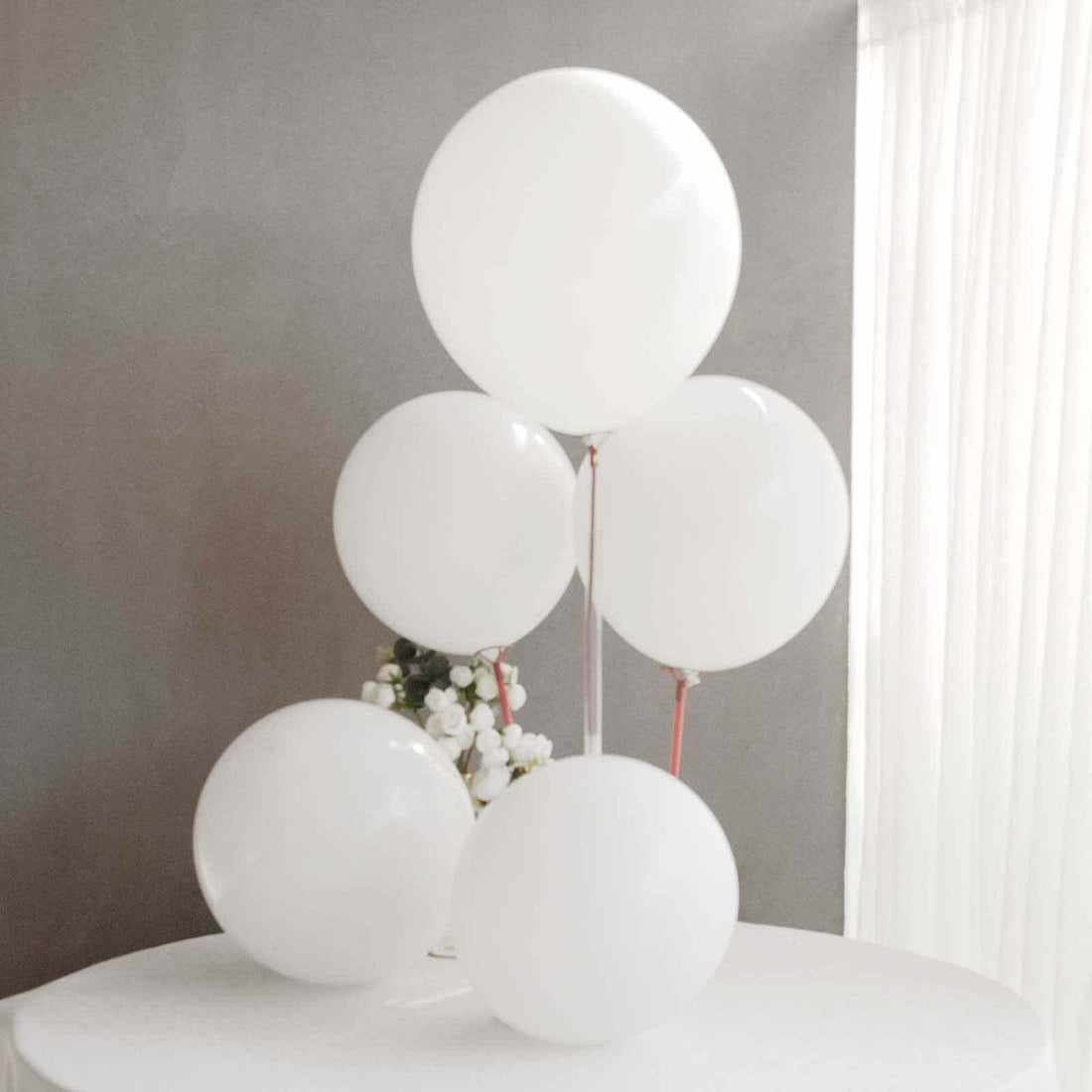 White balloons arranged elegantly on a table