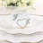 Gold heart-shaped card holder with floral design on a white card.