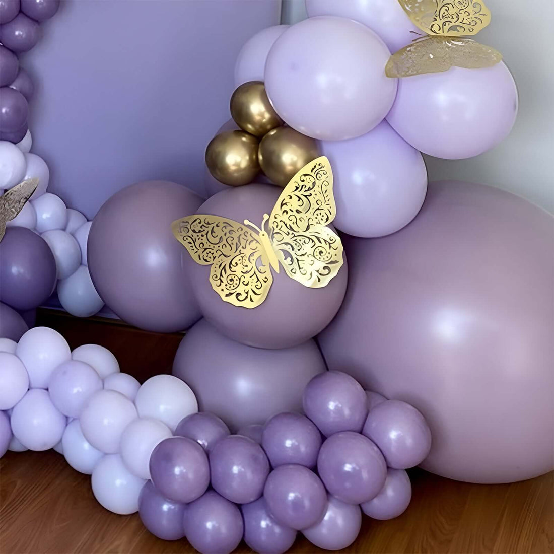 Purple balloon decoration with gold butterfly accents.