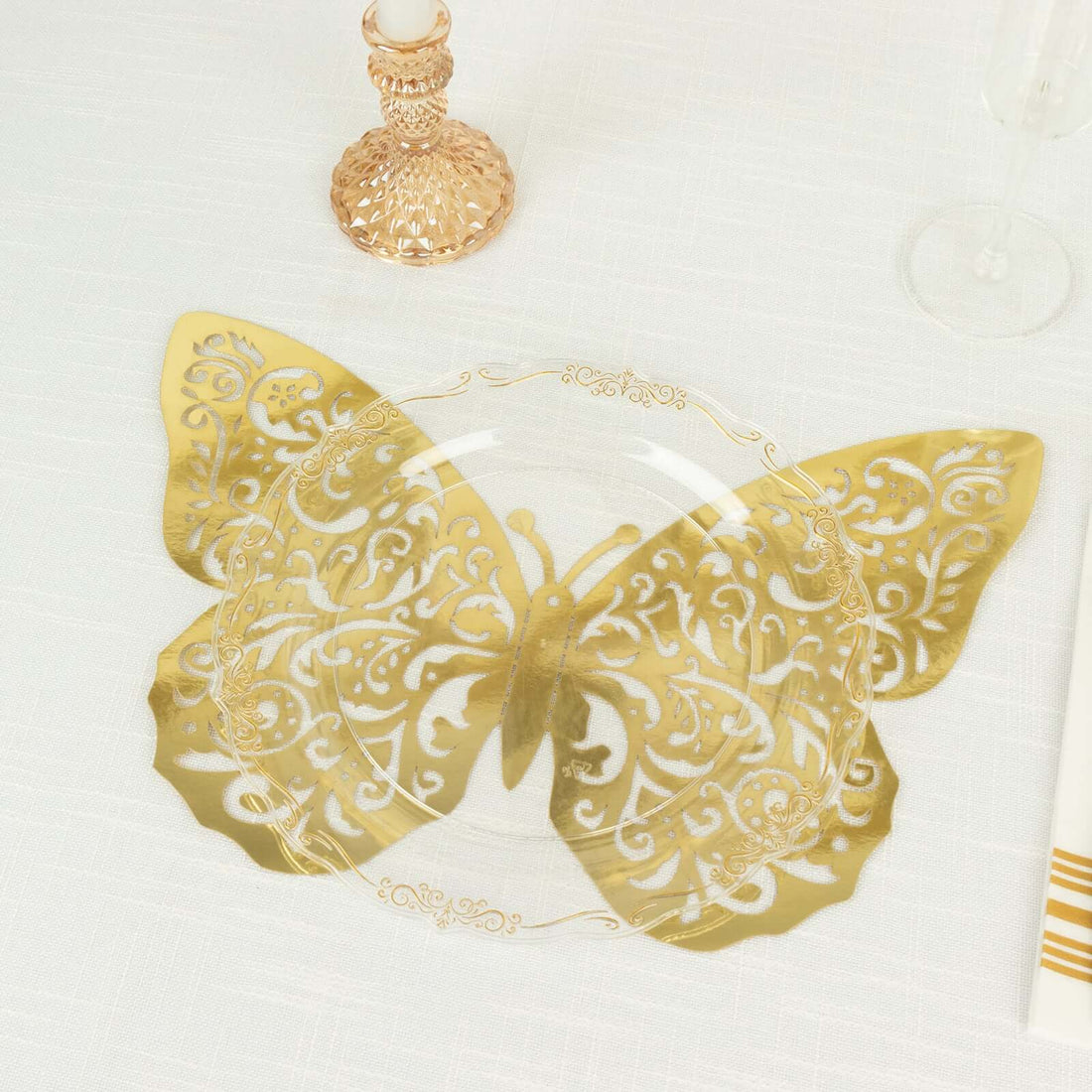 Gold butterfly decorative plate on a table setting.