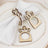 Wooden crown napkin holders on a decorative plate with white napkins.