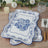 Decorative blue and white floral serving trays on a wooden table.