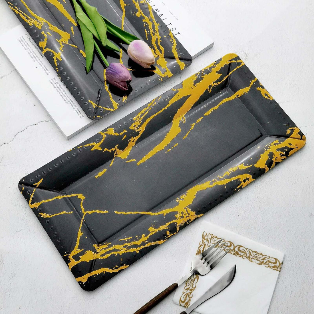 Black and gold marbled serving tray on a white background