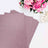 Glitter pink cardstock sheets arranged with pink flowers