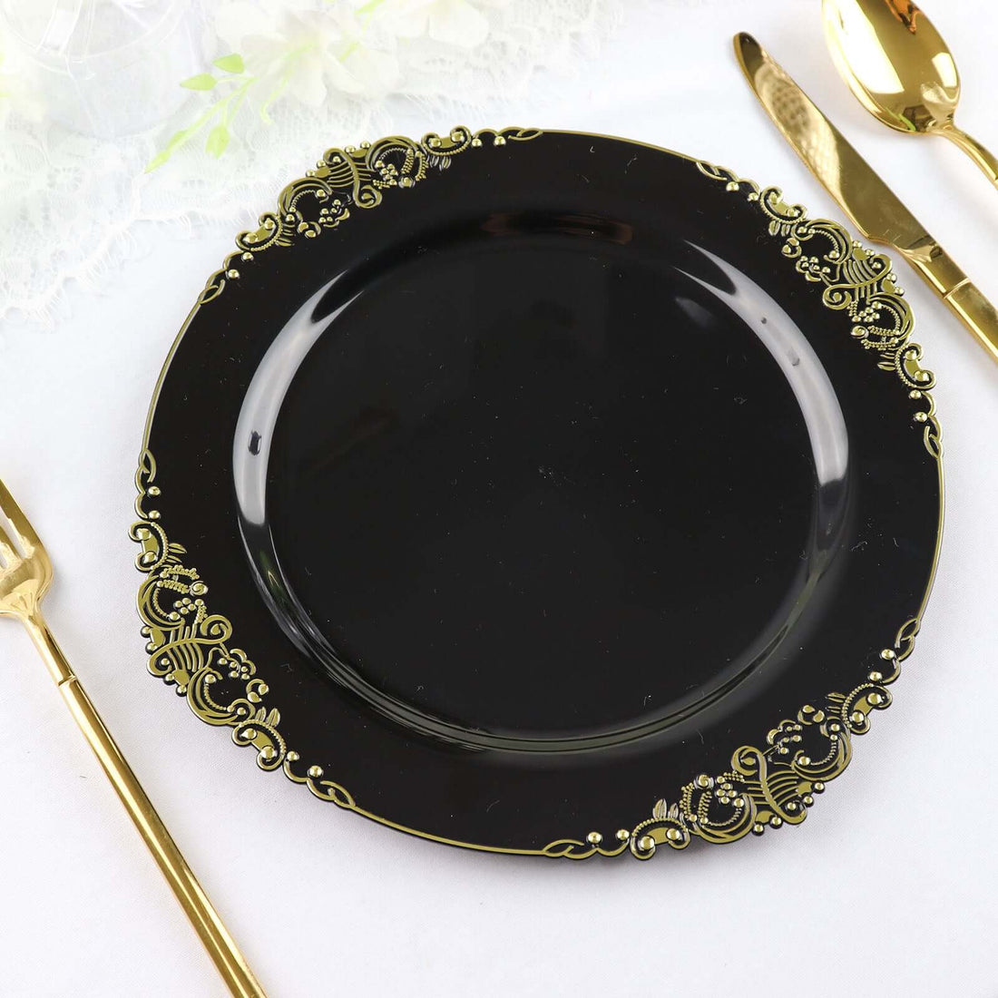 Elegant black dinner plate with gold ornate rim design.