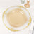 Elegant gold-trimmed glass plate on a dining table.