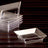 Clear acrylic serving dishes stacked on a wooden surface.