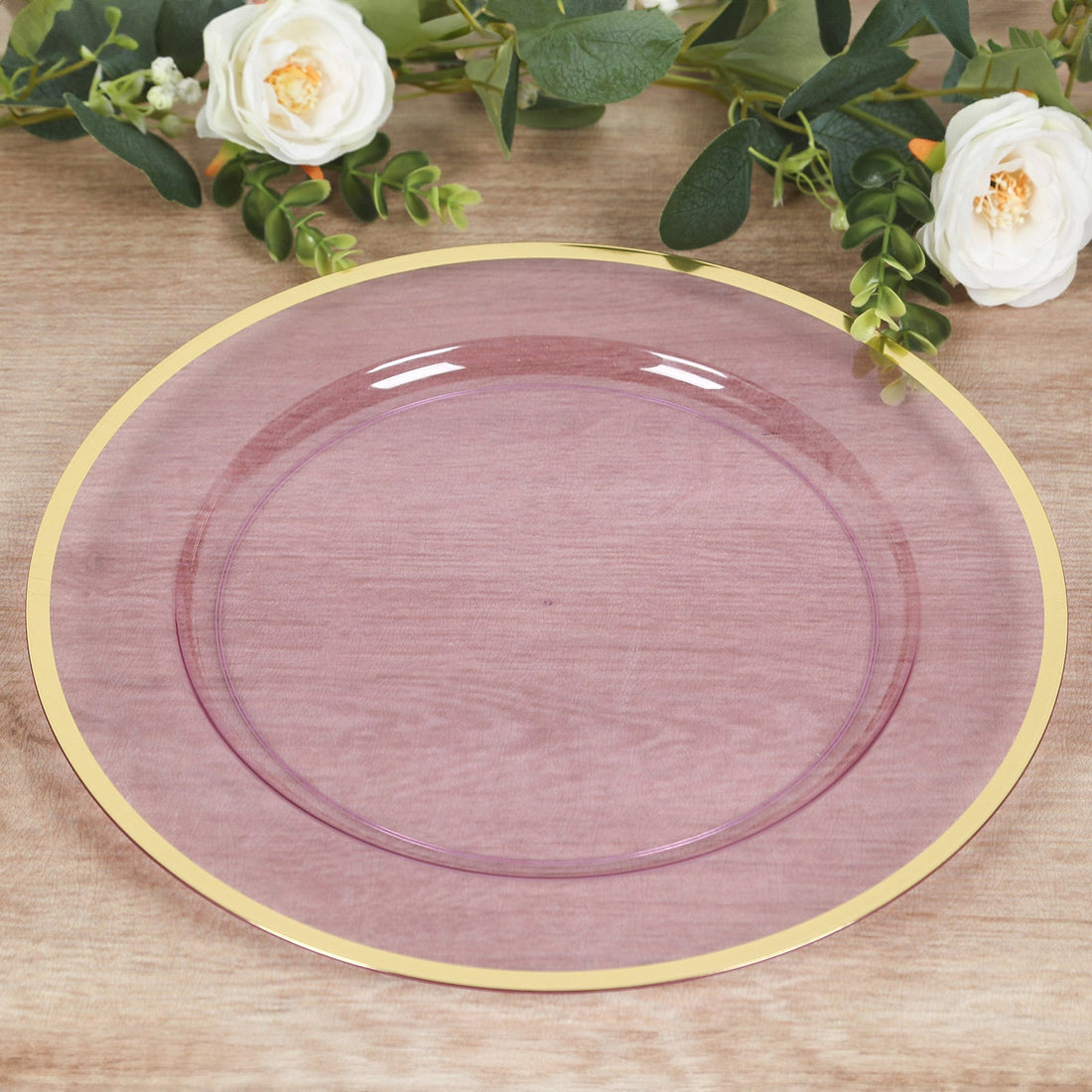 Purple glass plate with gold rim on a wooden surface.