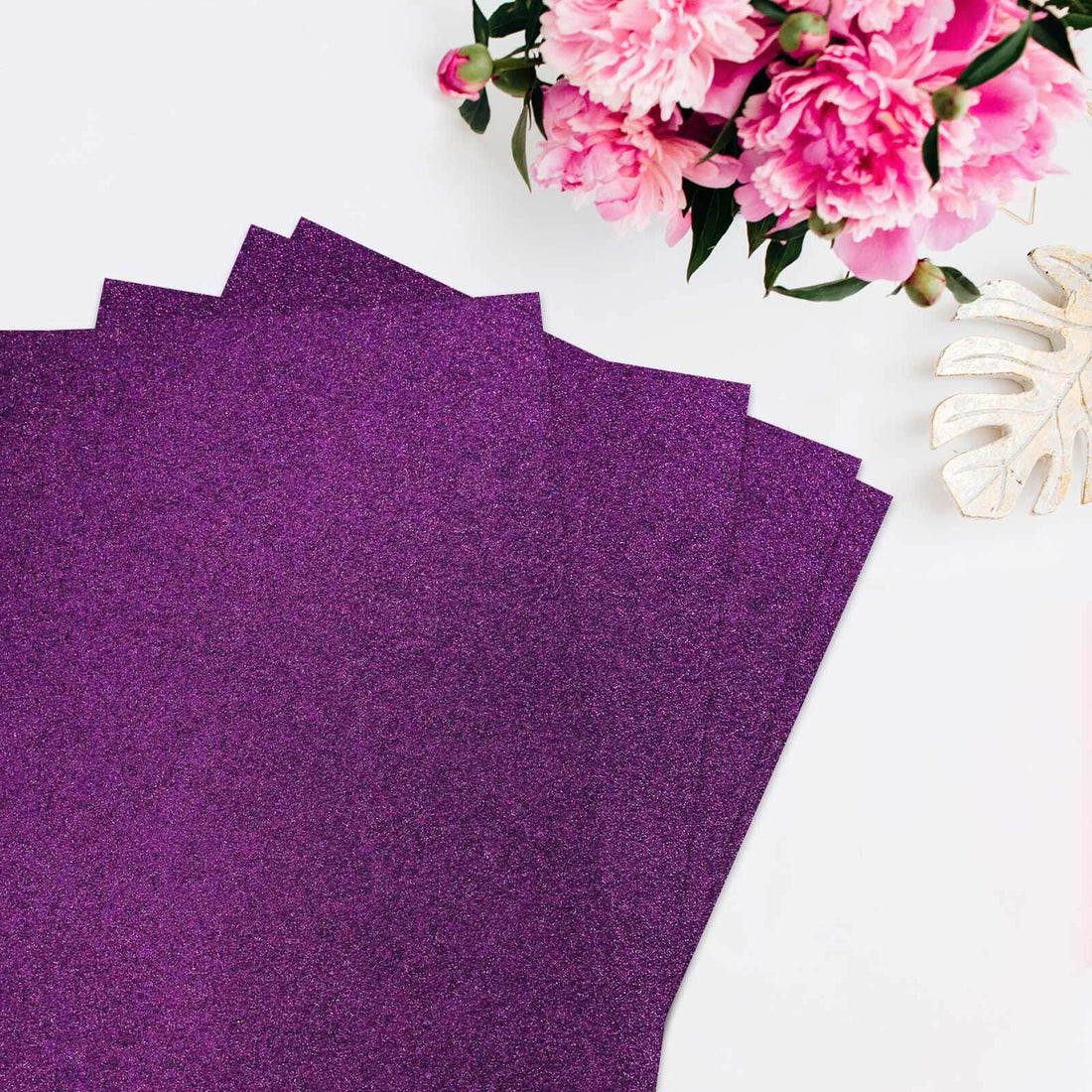 Purple glitter cardstock sheets with floral arrangement