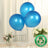 Three blue biodegradable balloons on a table with flowers and decor.