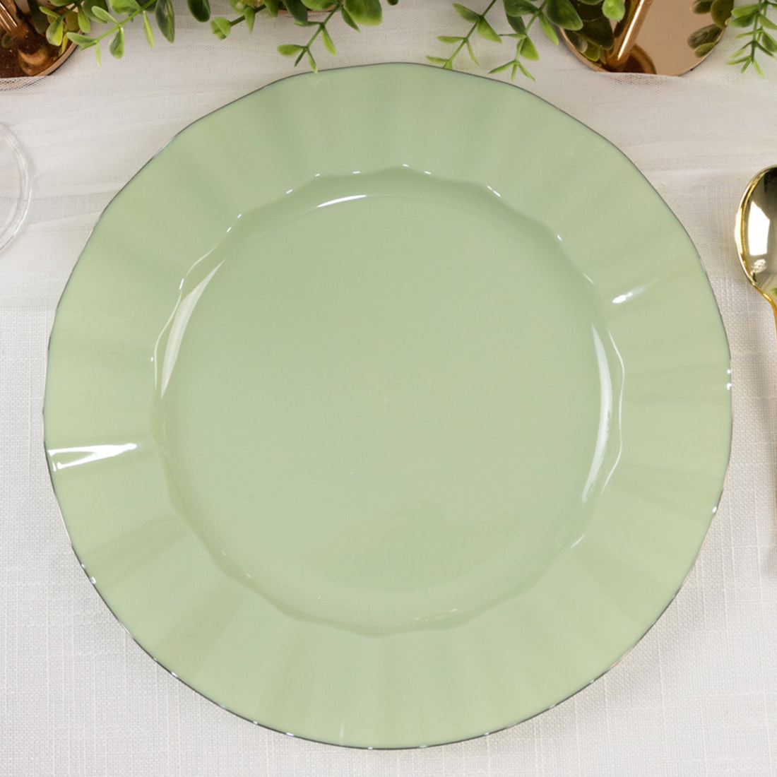 Mint green decorative plate with a scalloped edge on a light background.