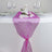 Purple table runner with floral decoration and wine glasses on a dining table. #whtbkgd