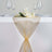 Elegant gold table runner with floral arrangement and wine glasses. #whtbkgd