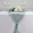 Elegant green table runner with floral arrangement and glassware #whtbkgd