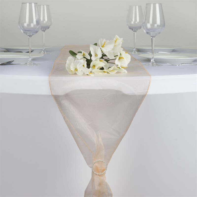 Elegant table runner with floral centerpiece and glassware. #whtbkgd