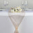 Elegant table runner with floral centerpiece and glassware. #whtbkgd