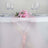 Pink table runner with flowers and glassware on a white table. #whtbkgd