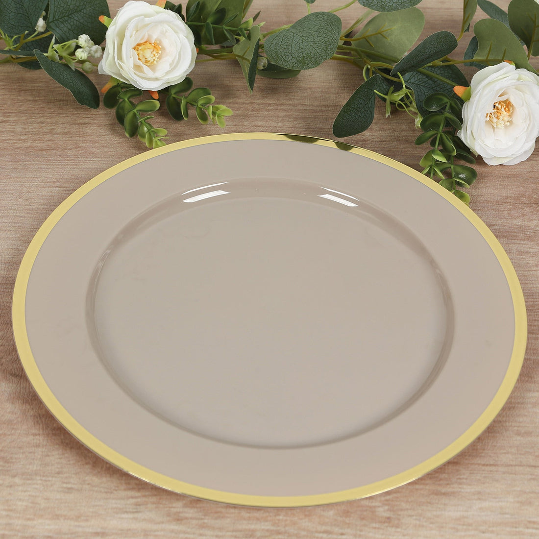 Elegant beige plate with gold rim on a wooden surface.