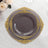 Elegant decorative plate with gold accents on a dark background.