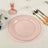 Pink glass plate with beaded edge on a table setting.