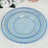 Set of three elegant blue decorative plates with beaded edges.